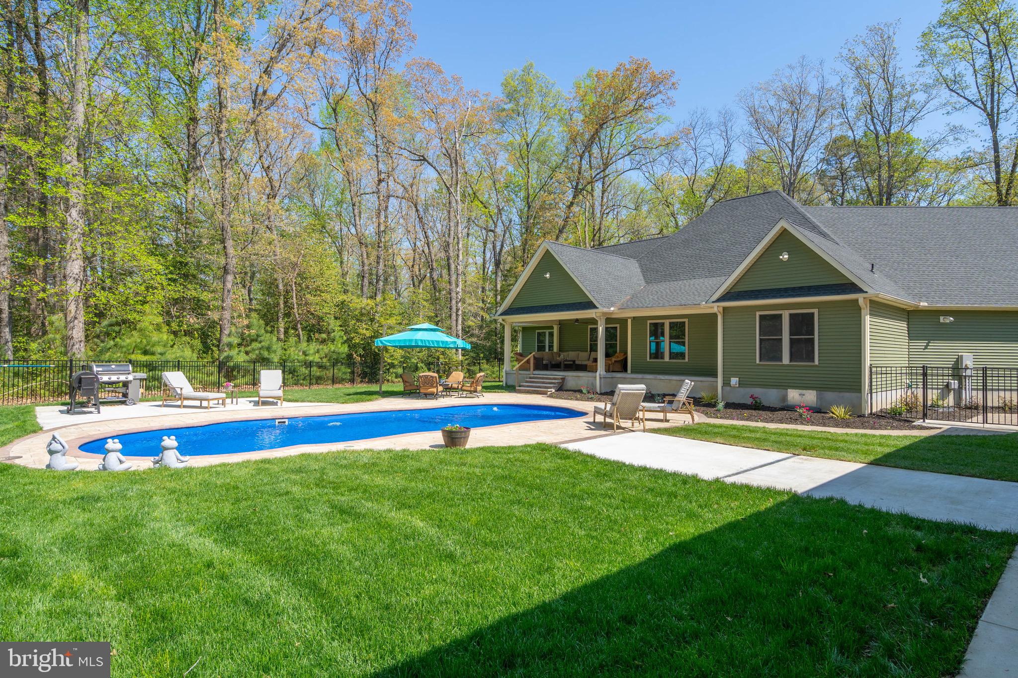 26750 Deep Branch Road Milton, DE 19968 - Photo 25 of 96 a view of a house with swimming pool and a yard