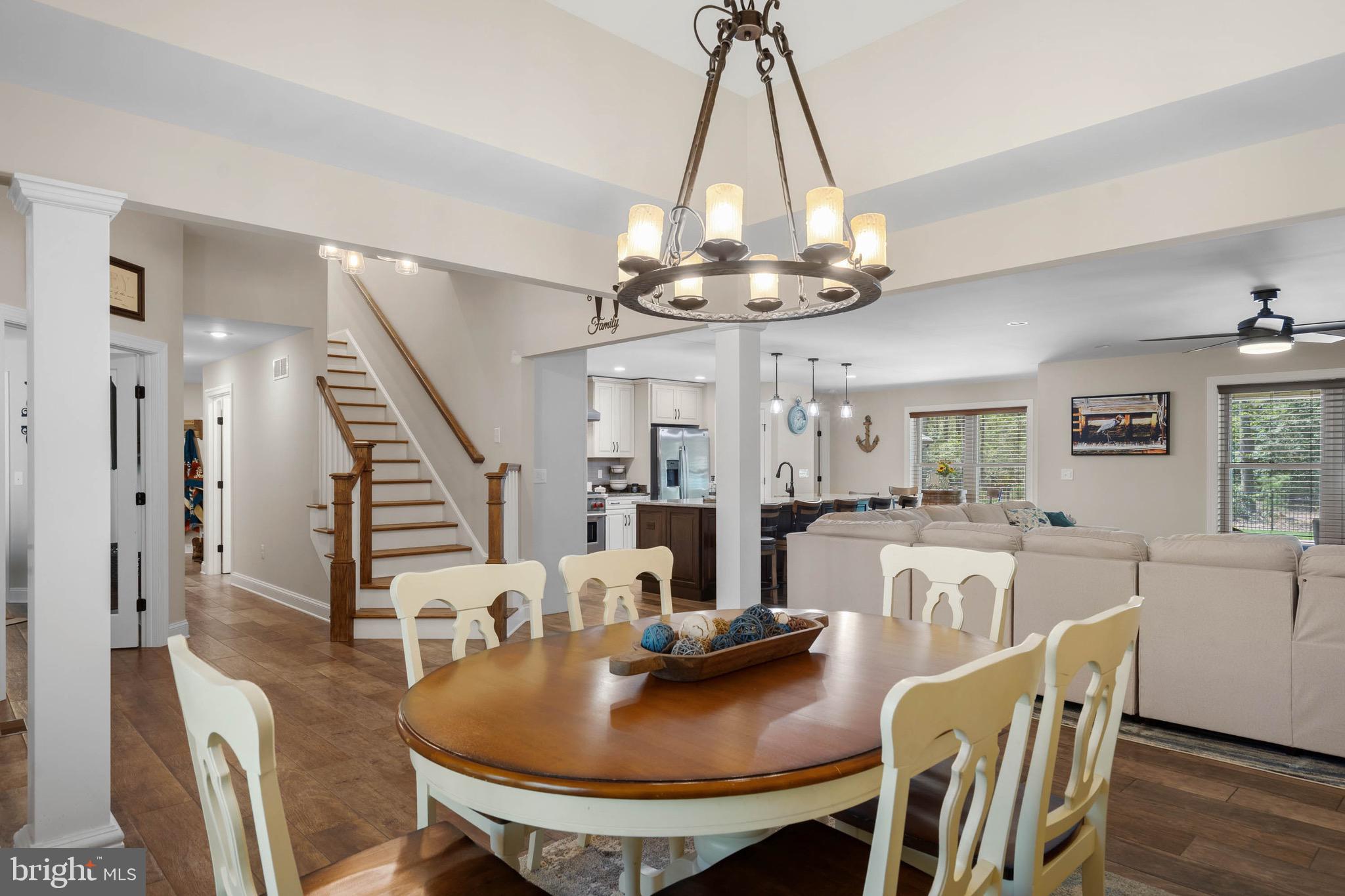 26750 Deep Branch Road Milton, DE 19968 - Photo 55 of 96 a dining room with furniture a chandelier and wooden floor