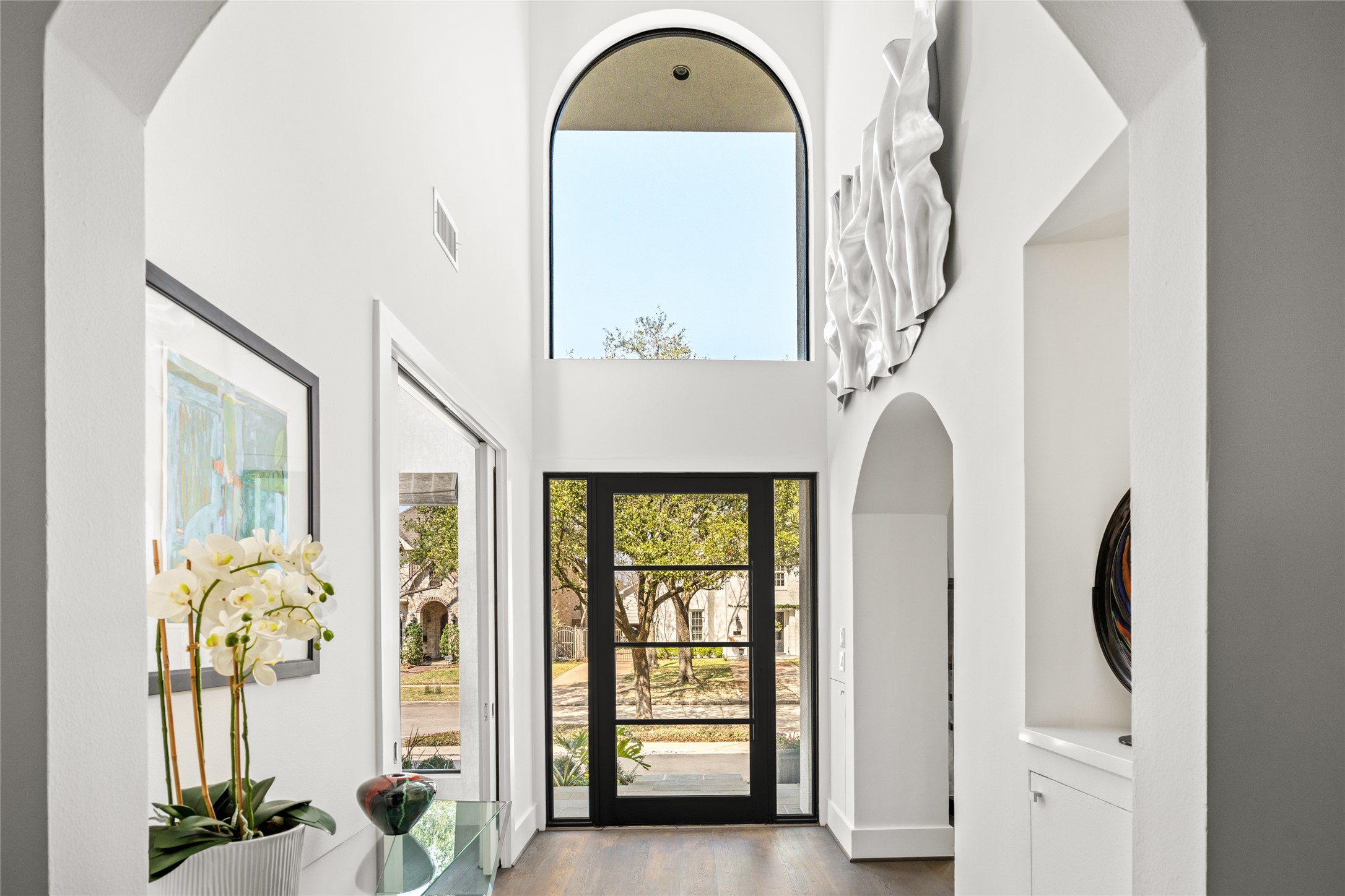 3703 Wroxton Road West University Place, TX 77005 - Photo 3 of 50 Bright, modern entryway with high ceilings and large windows. The space is inviting with a clear view to the outdoors.