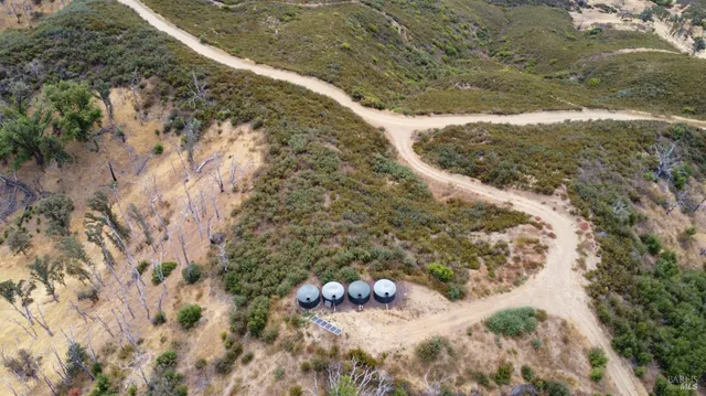 an aerial view of a house with a mountain