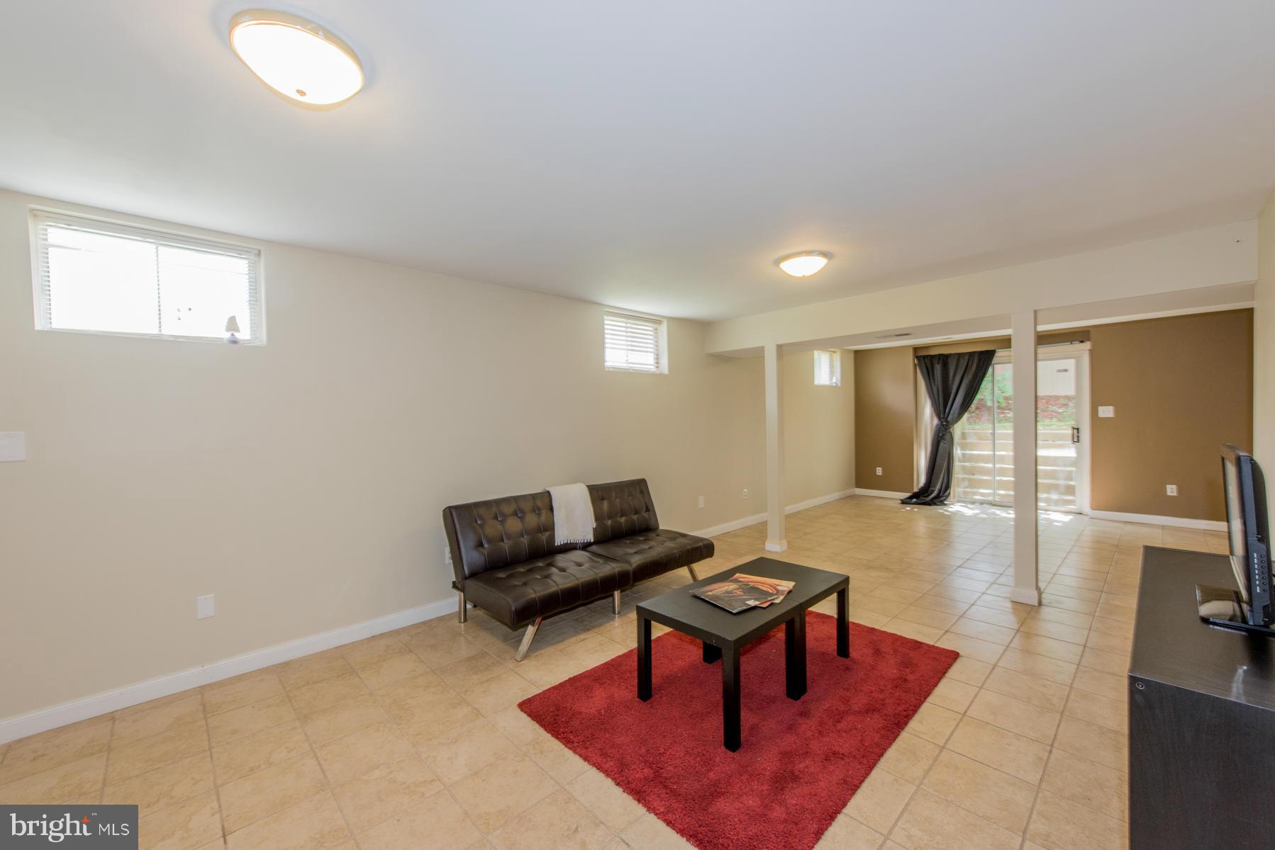11606 Letterman Way Gaithersburg, MD 20878 - Photo 29 of 30 a living room with furniture a rug and a table