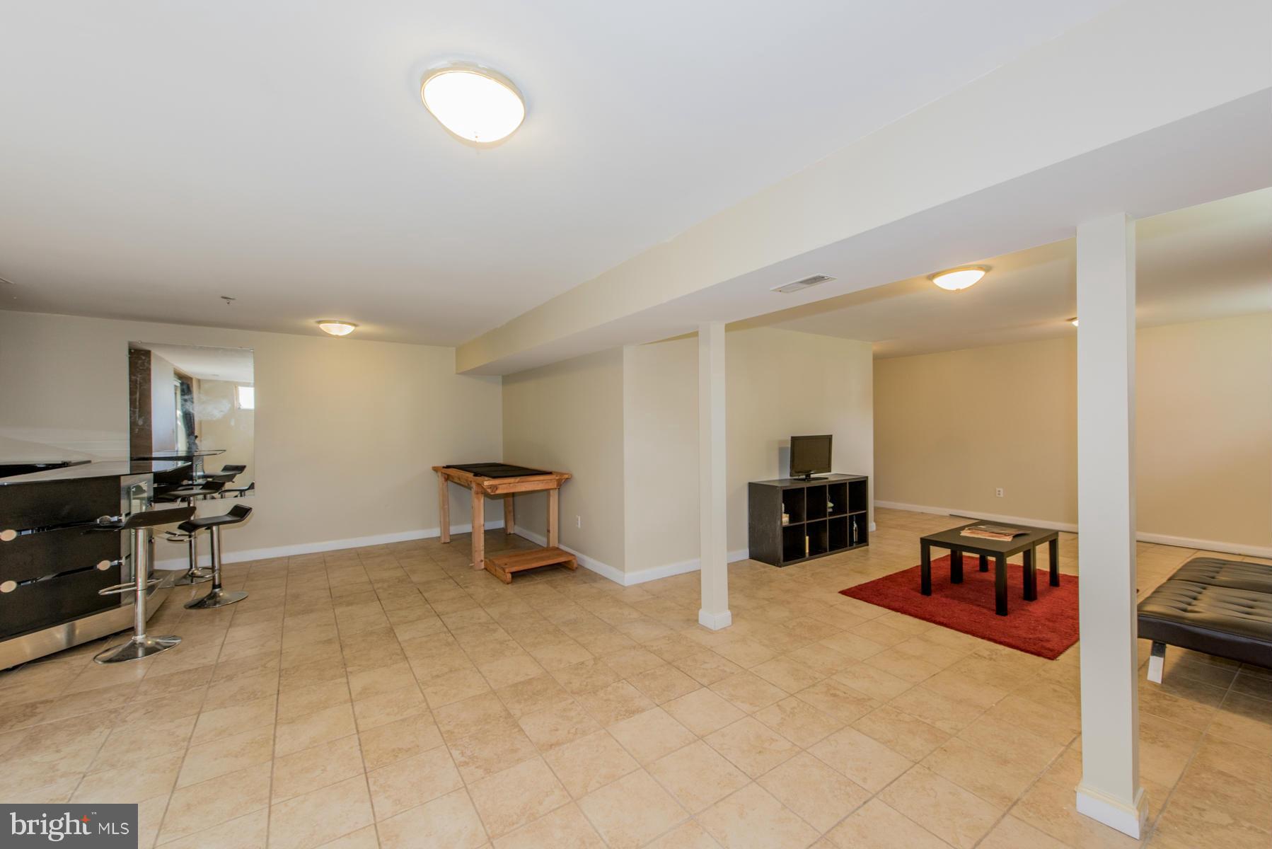 11606 Letterman Way Gaithersburg, MD 20878 - Photo 30 of 30 a living room with furniture and a wooden floor