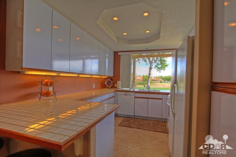 39 Colonial Drive Rancho Mirage, CA 92270 - Photo 11 of 34 a kitchen with kitchen island a sink window and cabinets