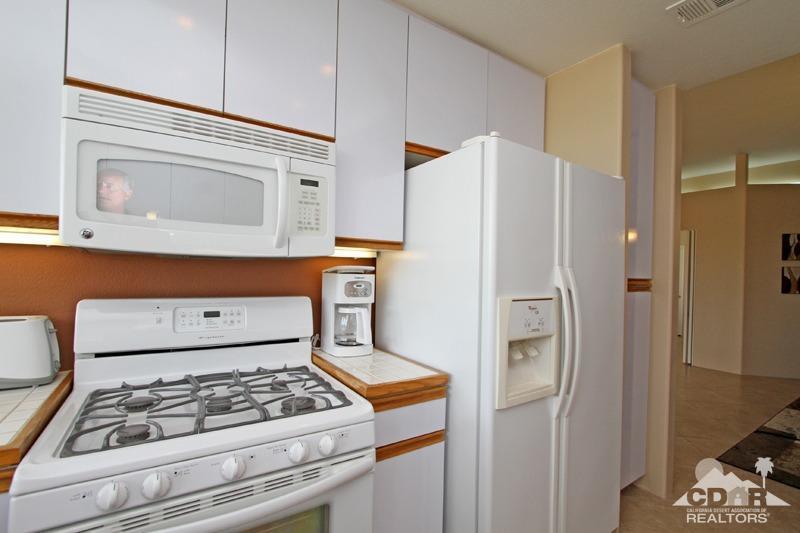 39 Colonial Drive Rancho Mirage, CA 92270 - Photo 14 of 34 a kitchen with stainless steel appliances granite countertop a refrigerator and a stove
