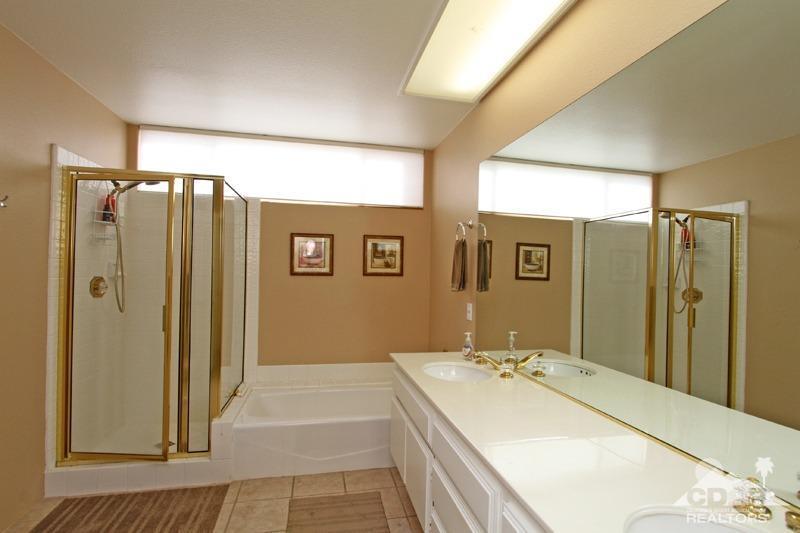 39 Colonial Drive Rancho Mirage, CA 92270 - Photo 21 of 34 a spacious bathroom with a double vanity sink and mirror