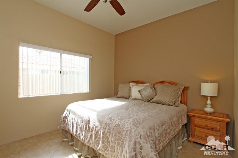 39 Colonial Drive Rancho Mirage, CA 92270 - Photo 22 of 34 a bedroom with a bed and a night stand