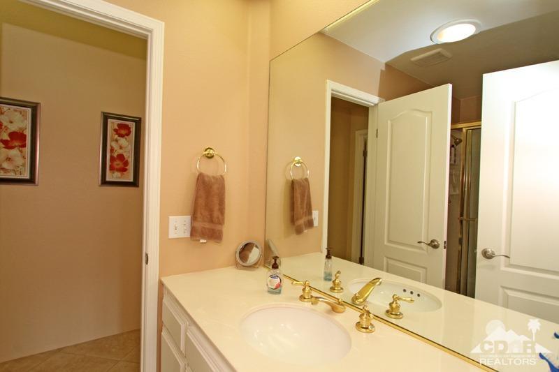 39 Colonial Drive Rancho Mirage, CA 92270 - Photo 24 of 34 a bathroom with a granite countertop sink and a mirror