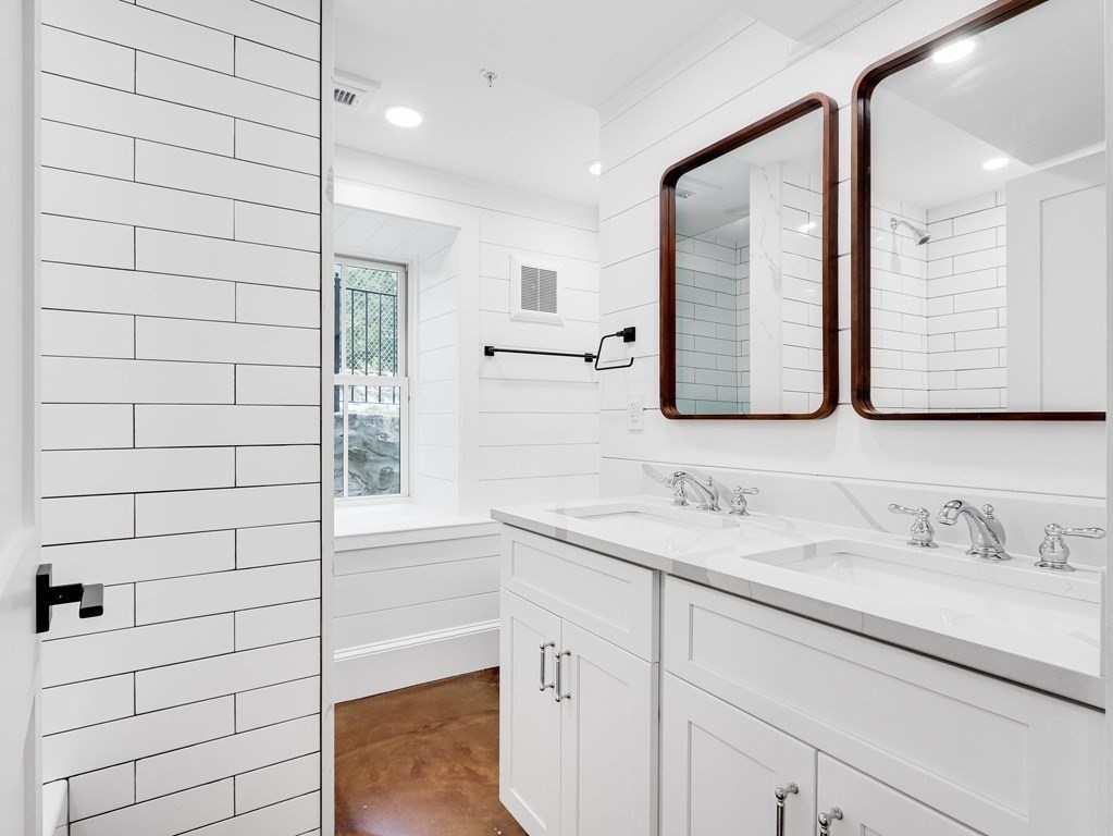 30 Copeland Street, Unit 1 Boston, MA 02119 - Photo 30 of 40 a bathroom with a sink and a mirror