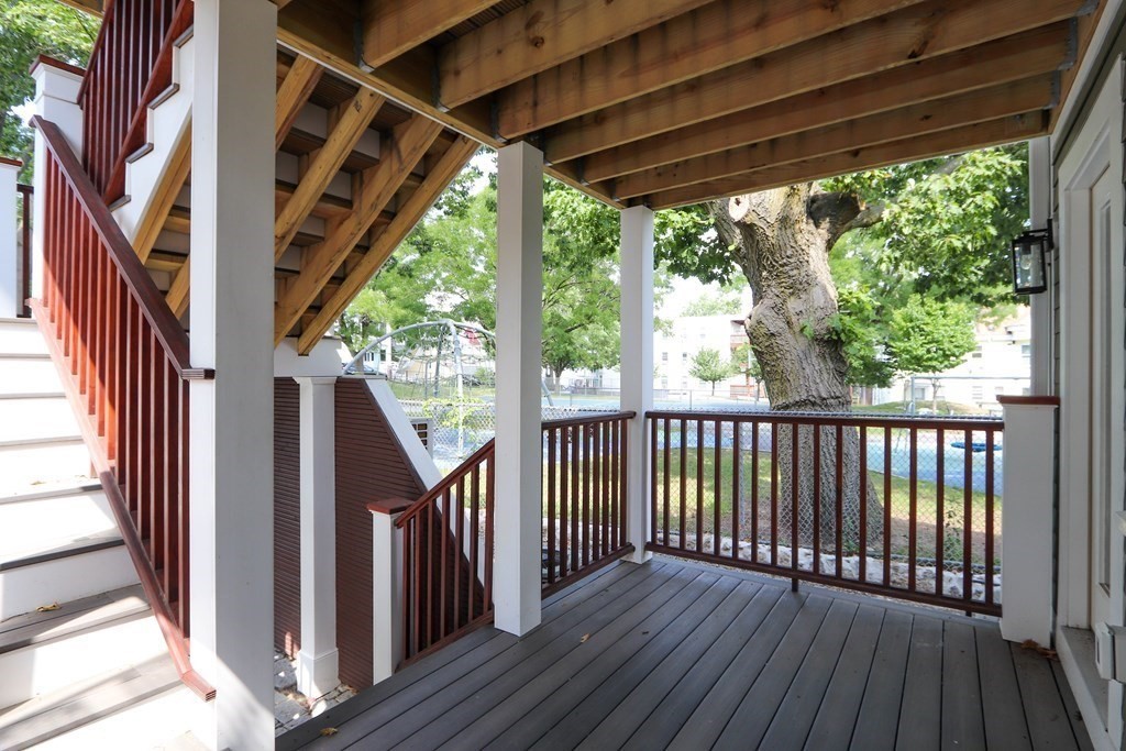 30 Copeland Street, Unit 1 Boston, MA 02119 - Photo 32 of 40 a view of balcony with wooden floor and iron stairs