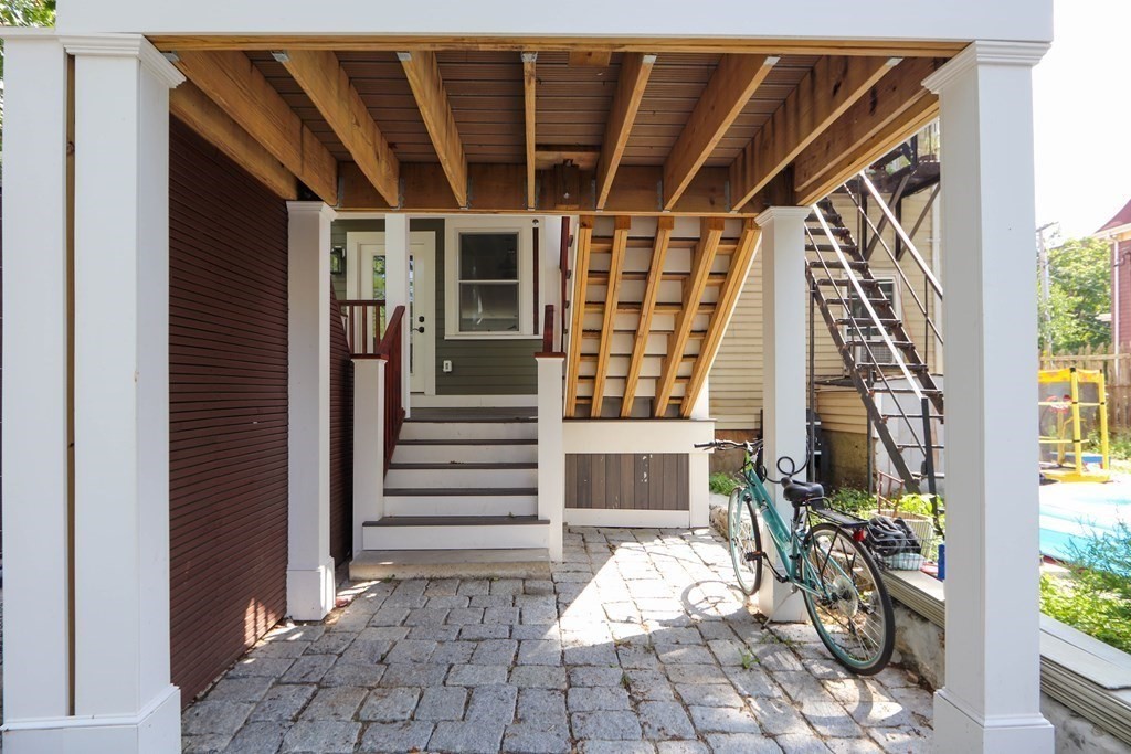 30 Copeland Street, Unit 1 Boston, MA 02119 - Photo 39 of 40 a view of a patio with table and chairs and potted plants