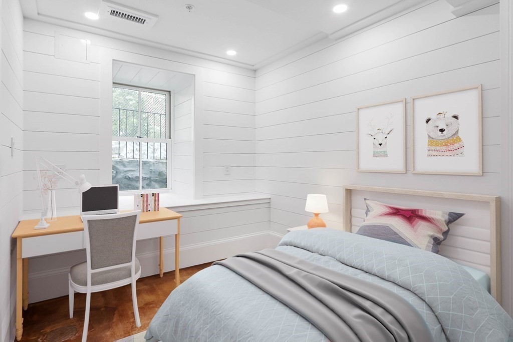 30 Copeland Street, Unit 1 Boston, MA 02119 - Photo 4 of 40 a bedroom with a bed and a table in it