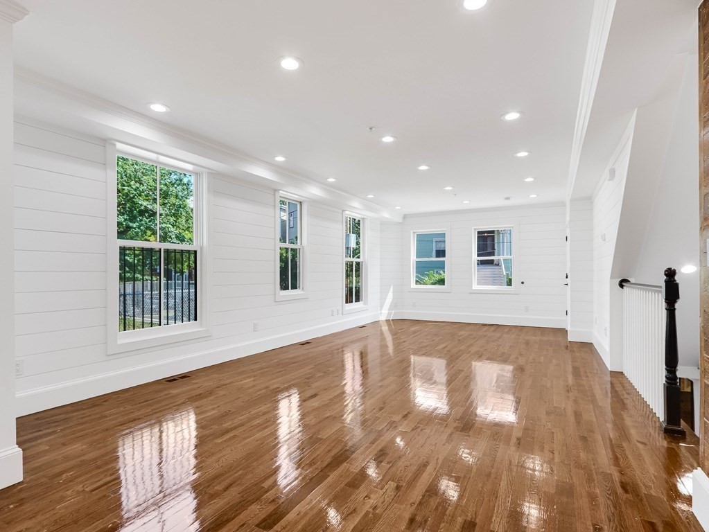 30 Copeland Street, Unit 1 Boston, MA 02119 - Photo 10 of 40 a view of an empty room with wooden floor and a window