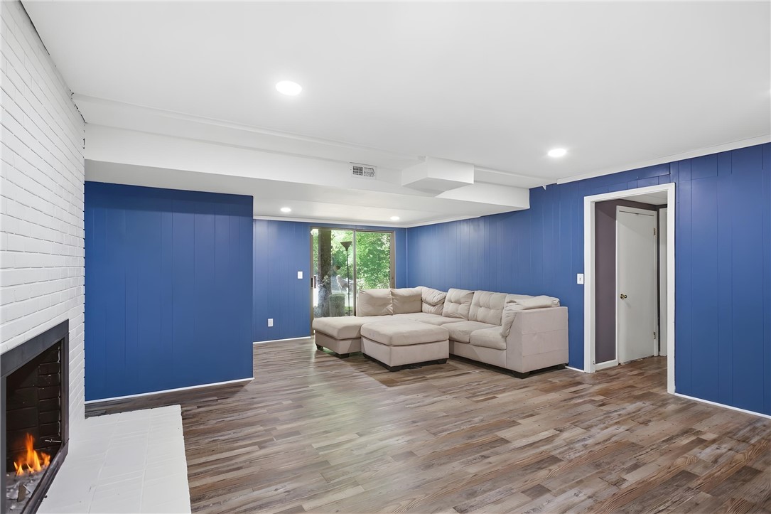 311 Cumberland Way Anderson, SC 29621 - Photo 29 of 44 A vibrant living area features a warm fireplace and seamless access to the outdoors.