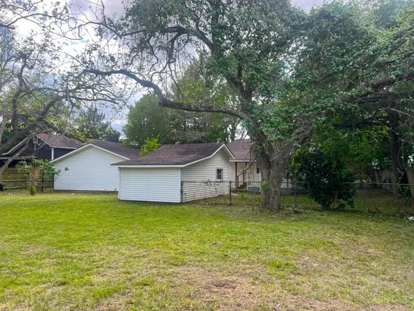 a view of backyard of house with trees