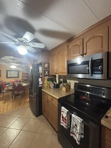 a kitchen with granite countertop a stove and a refrigerator