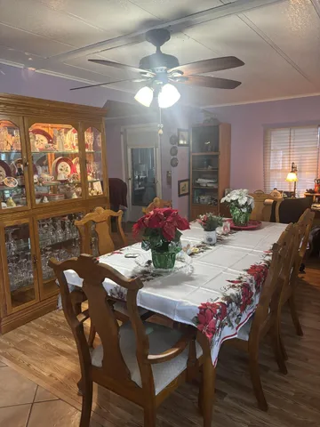a view of a dining room with furniture and chandelier