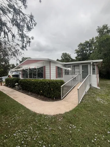 a front view of house with yard and green space
