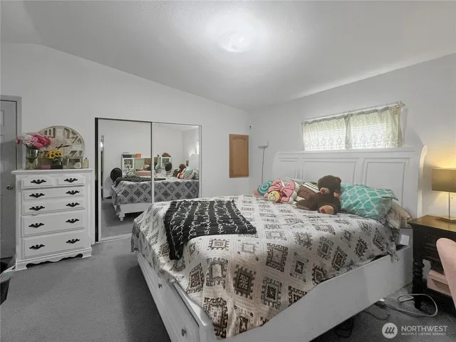 a bedroom with bed and window