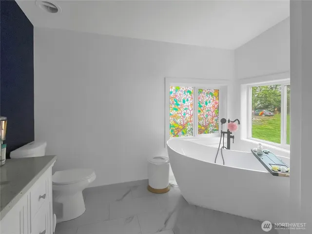 a bath tub sitting in a bathroom next to a window