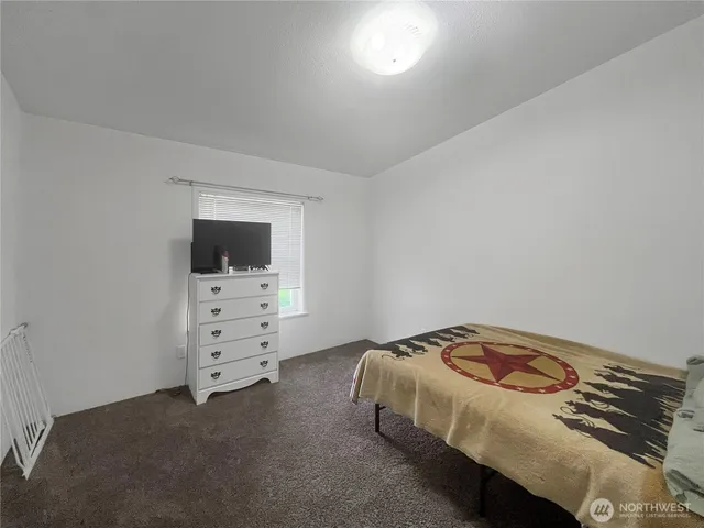a bedroom with a bed and tv