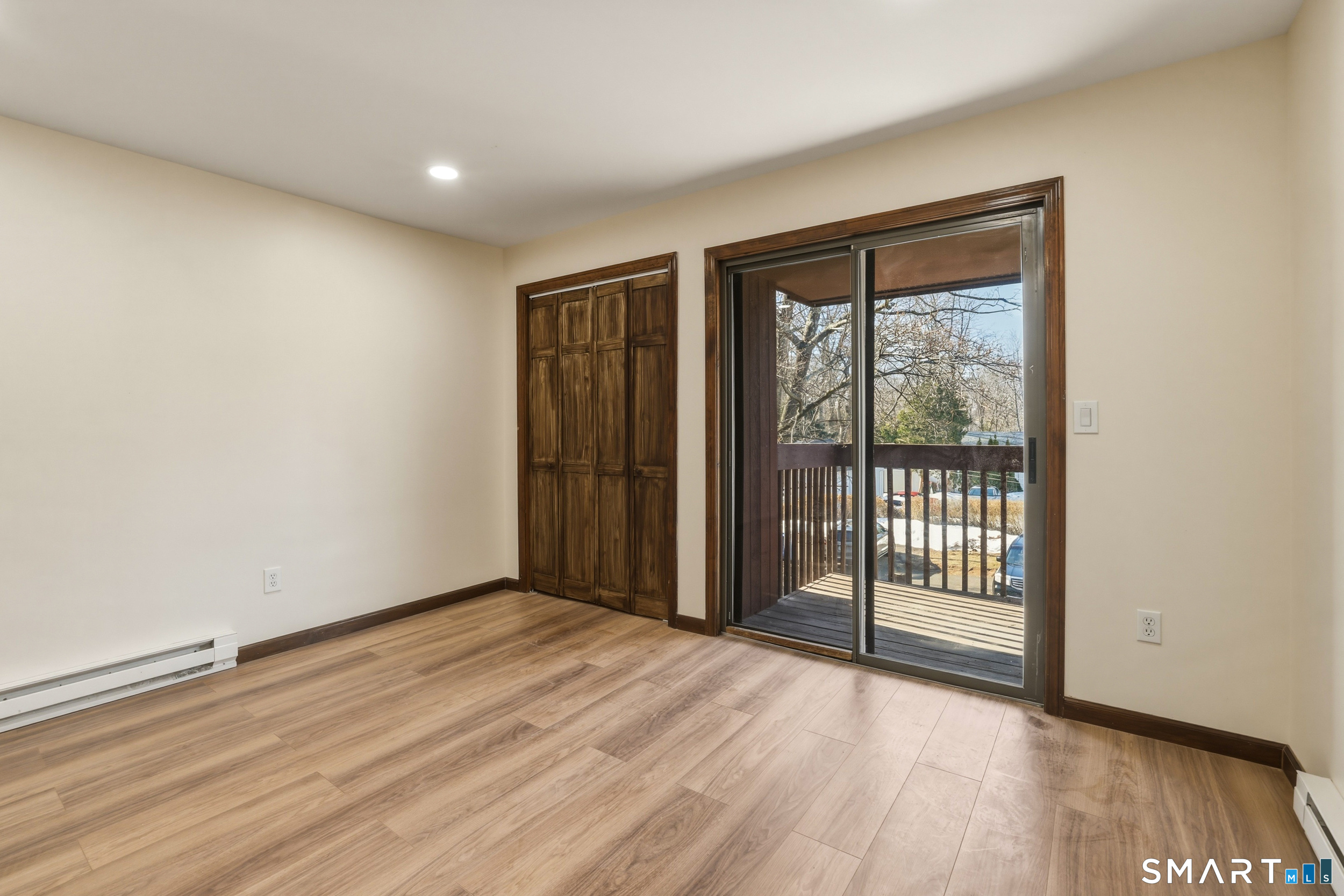 275 Broad Street, Unit 9 Meriden, CT 06450 - Photo 5 of 21 an empty room with wooden floor and windows