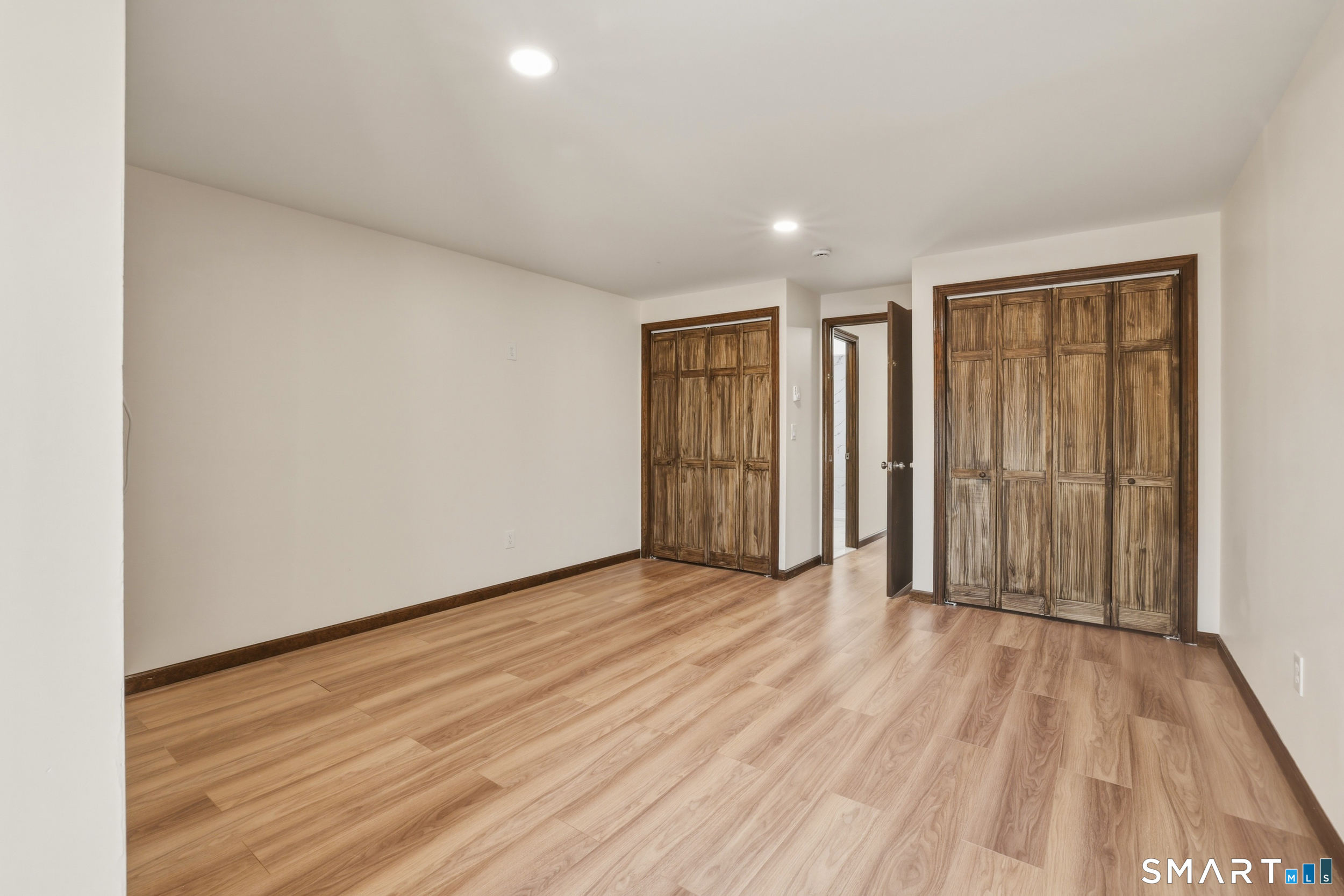 275 Broad Street, Unit 9 Meriden, CT 06450 - Photo 7 of 21 a view of an empty room with wooden floor
