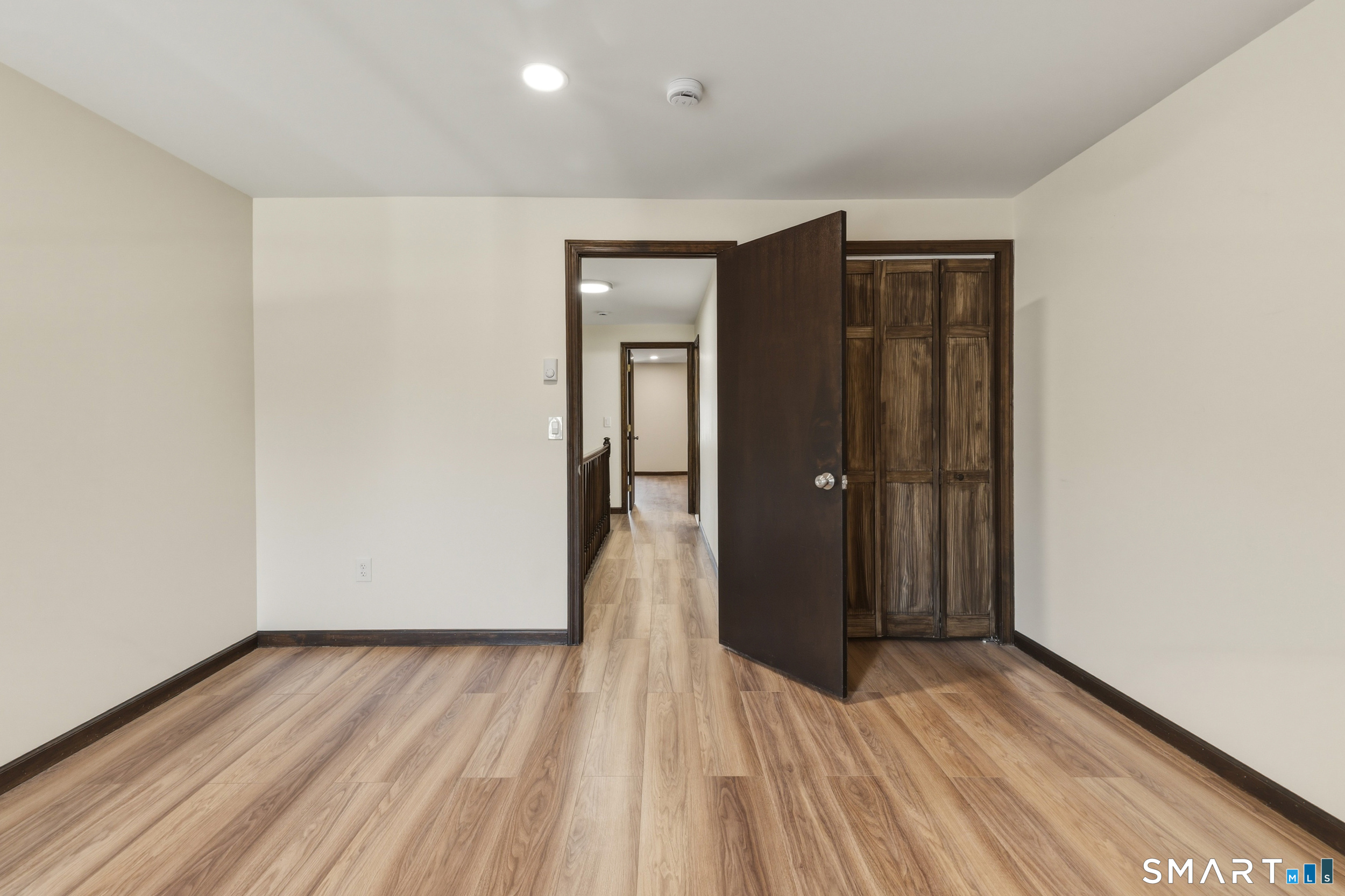 275 Broad Street, Unit 9 Meriden, CT 06450 - Photo 10 of 21 a view of a hallway with wooden floor and a bathroom