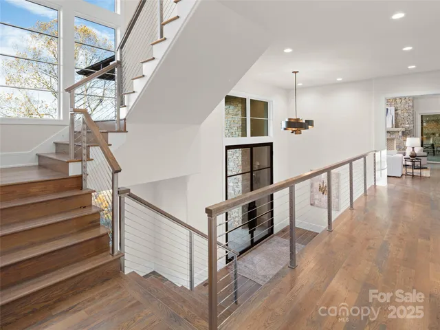 a living room with furniture a table and a large window