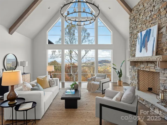 a living room with furniture a floor to ceiling window and a floor to ceiling window