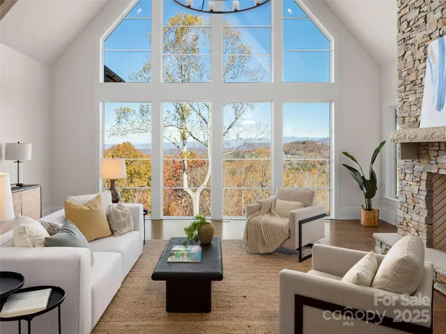 a kitchen with a dining table chairs and white cabinets