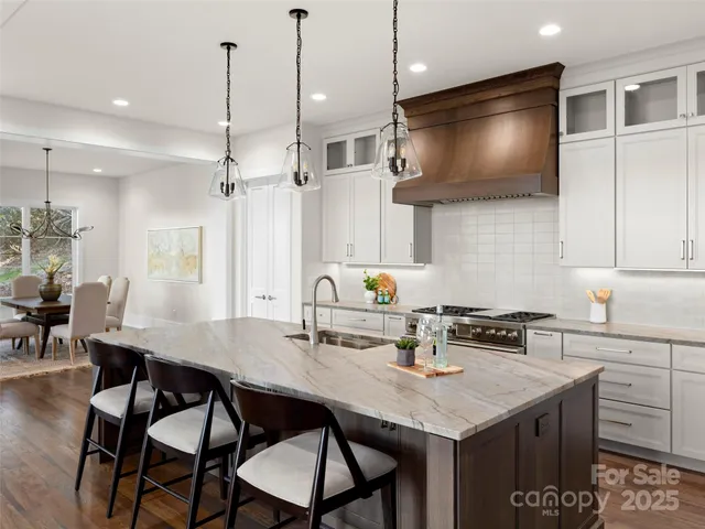 a open kitchen with stainless steel appliances granite countertop a lot of counter space and living room
