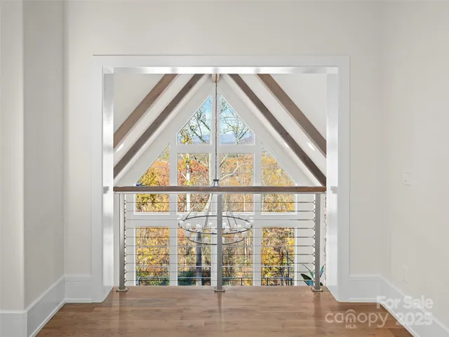 a big room with wooden floors and windows