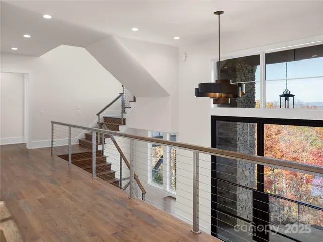 a view of entryway and hall with wooden floor