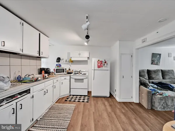 a kitchen with granite countertop a sink cabinets and stainless steel appliances