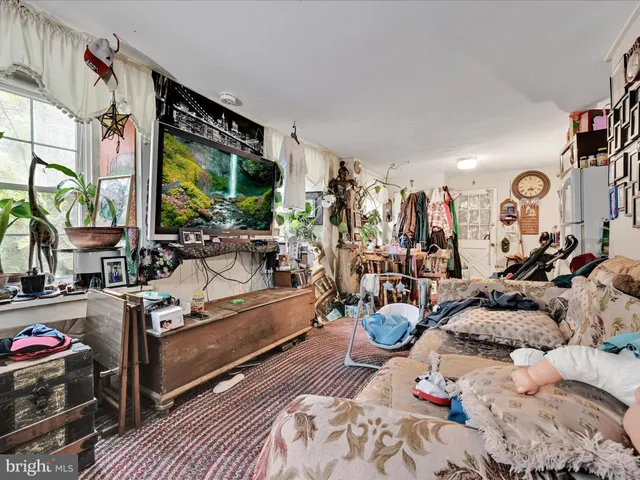 a living room with patio furniture and a large window