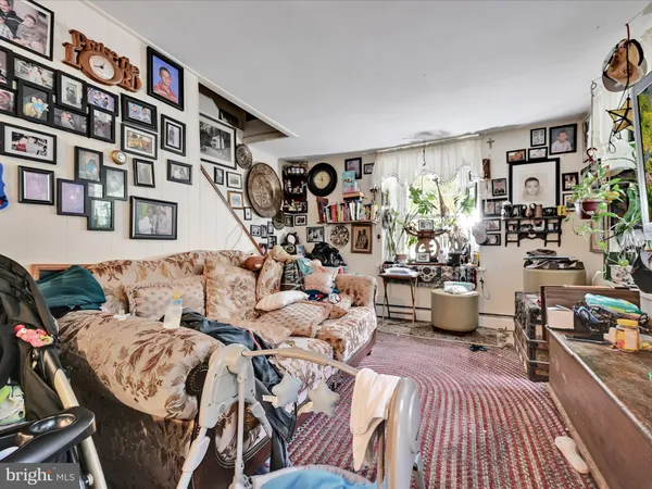 a living room with furniture and a book shelf