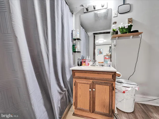 a bathroom with a sink a toilet and mirror