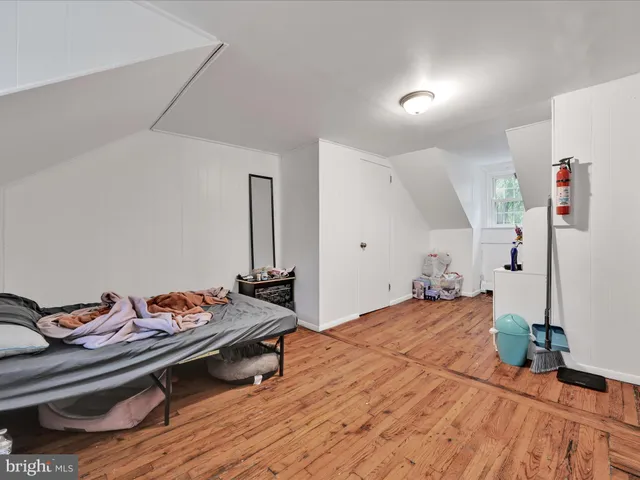 a bedroom with furniture and a wooden floor