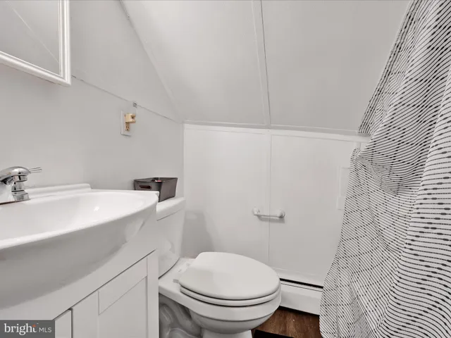 a bathroom with a sink a toilet and mirror