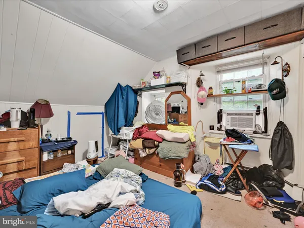 a bedroom with furniture and a wooden floor