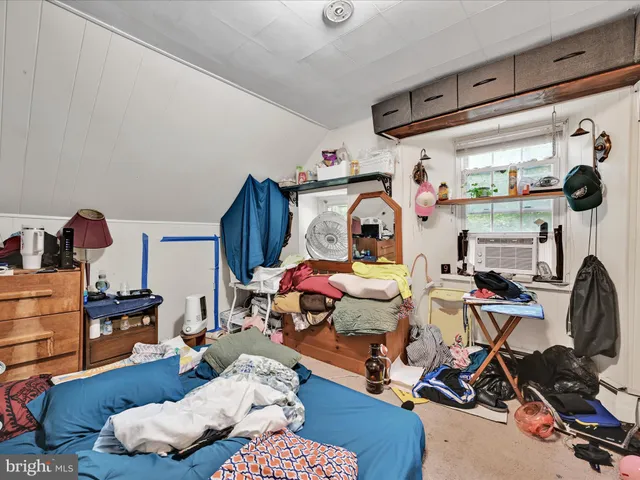 a bedroom with furniture and a wooden floor