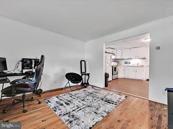 a view of a workspace with furniture and wooden floor
