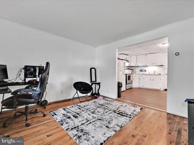 a view of a workspace with furniture and wooden floor