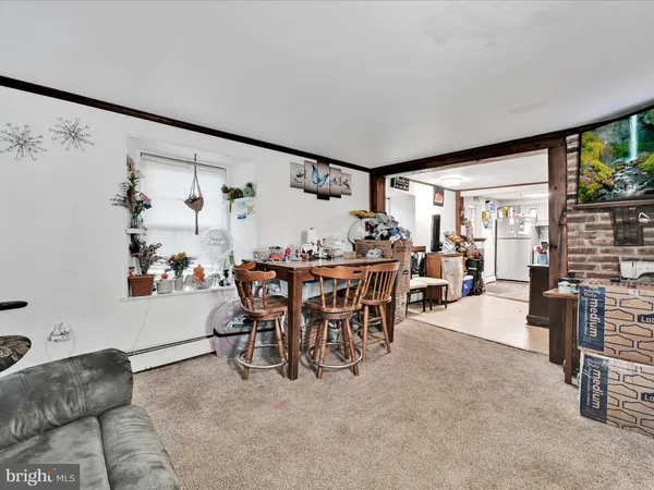 a dining room with furniture and window