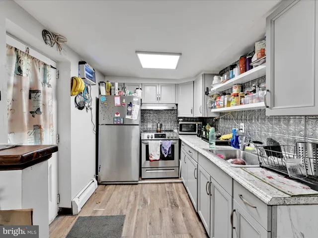 a kitchen with stainless steel appliances granite countertop a refrigerator and a stove