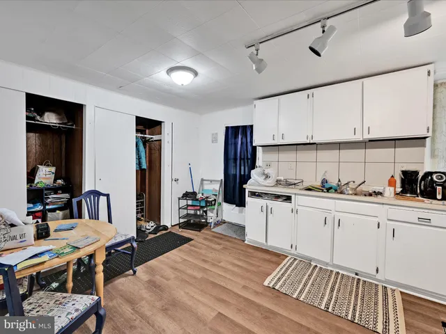 a kitchen with sink cabinets and wooden floor