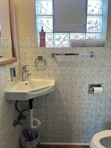 a bathroom with a sink a toilet and a window