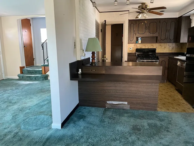a view of kitchen with cabinets and a fireplace