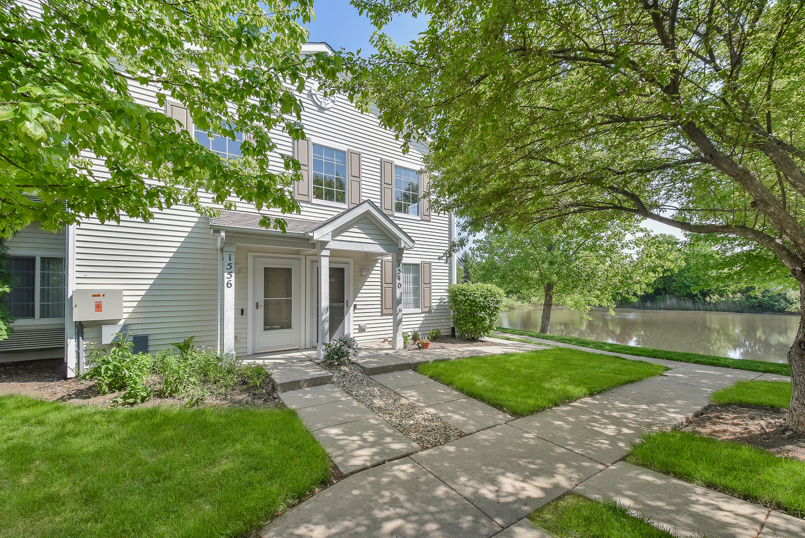1556 McClure Road, Unit 1556 Aurora, IL 60505 - Photo 1 of 17 a front view of a house with garden