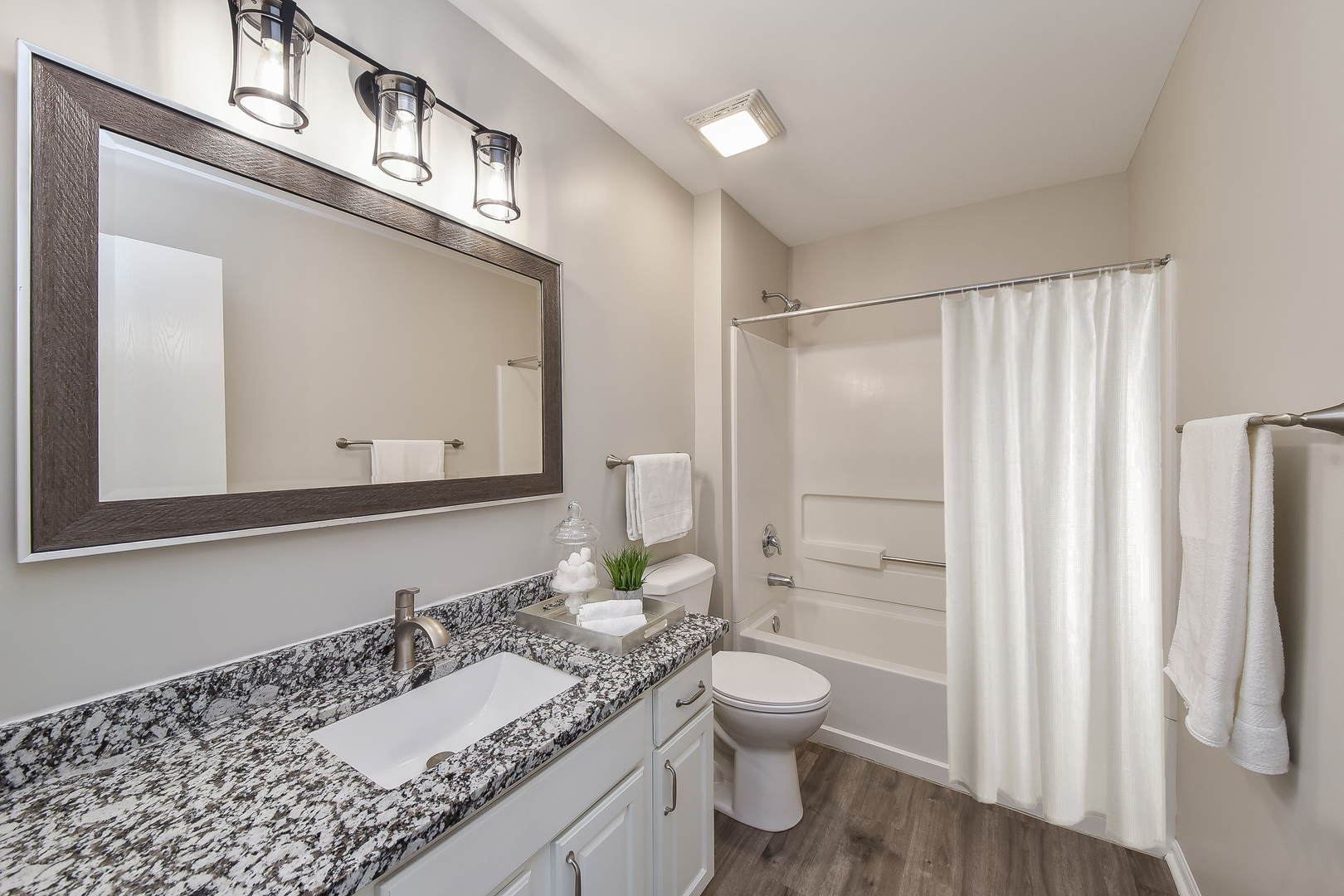 1556 McClure Road, Unit 1556 Aurora, IL 60505 - Photo 12 of 17 a bathroom with a granite countertop sink toilet and shower